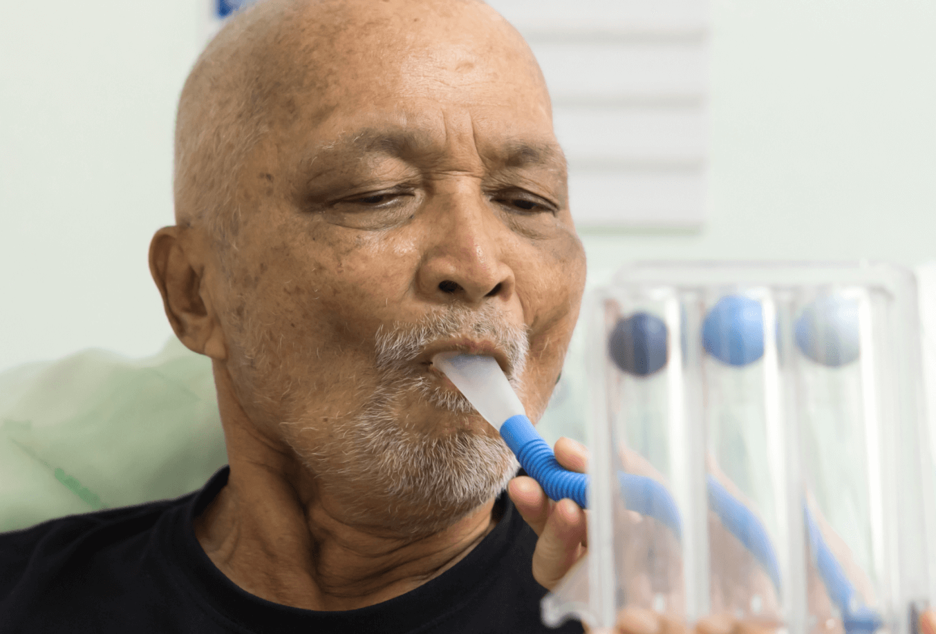 Elderly man doing breathing exercises
