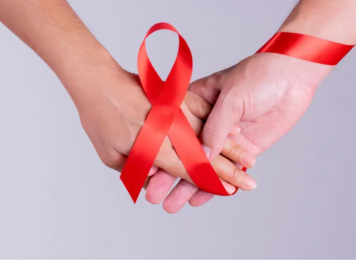 Two hands wrapped in a red ribbon