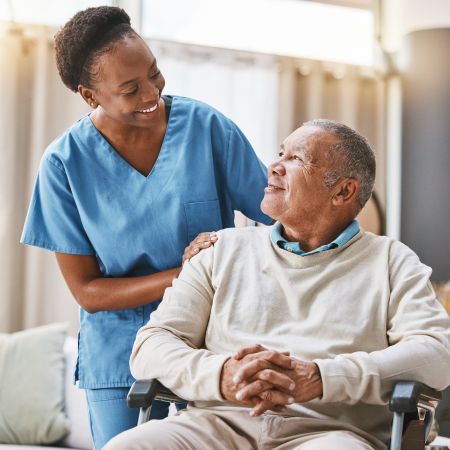 Nurse comforting a patient sitting in a chair