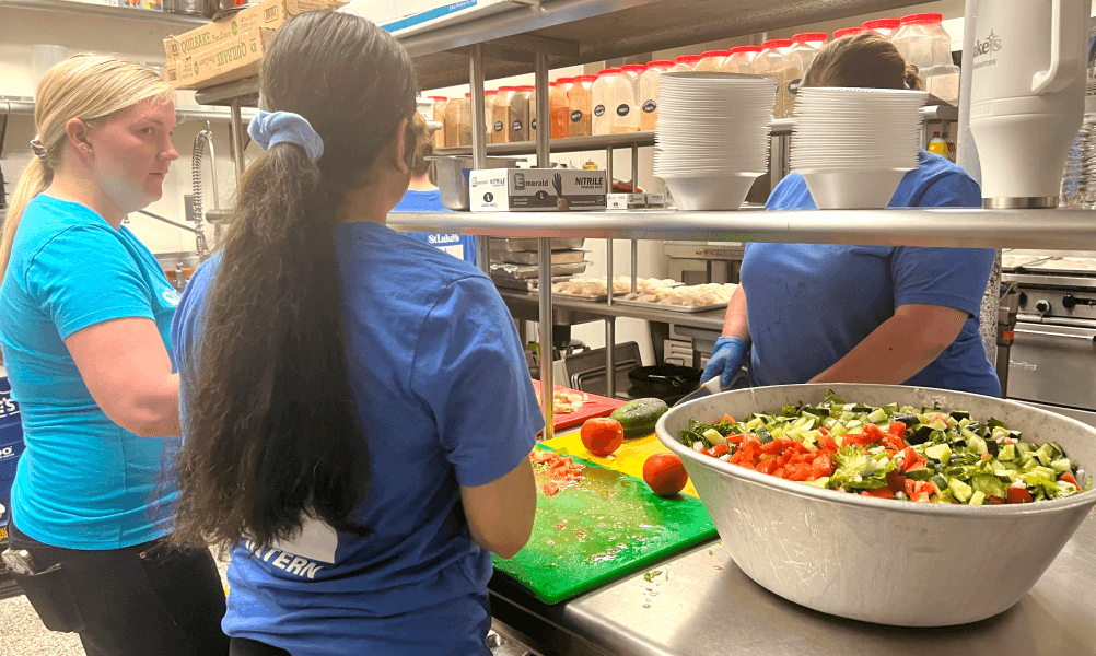 Interns helping prepare food in a kitchen