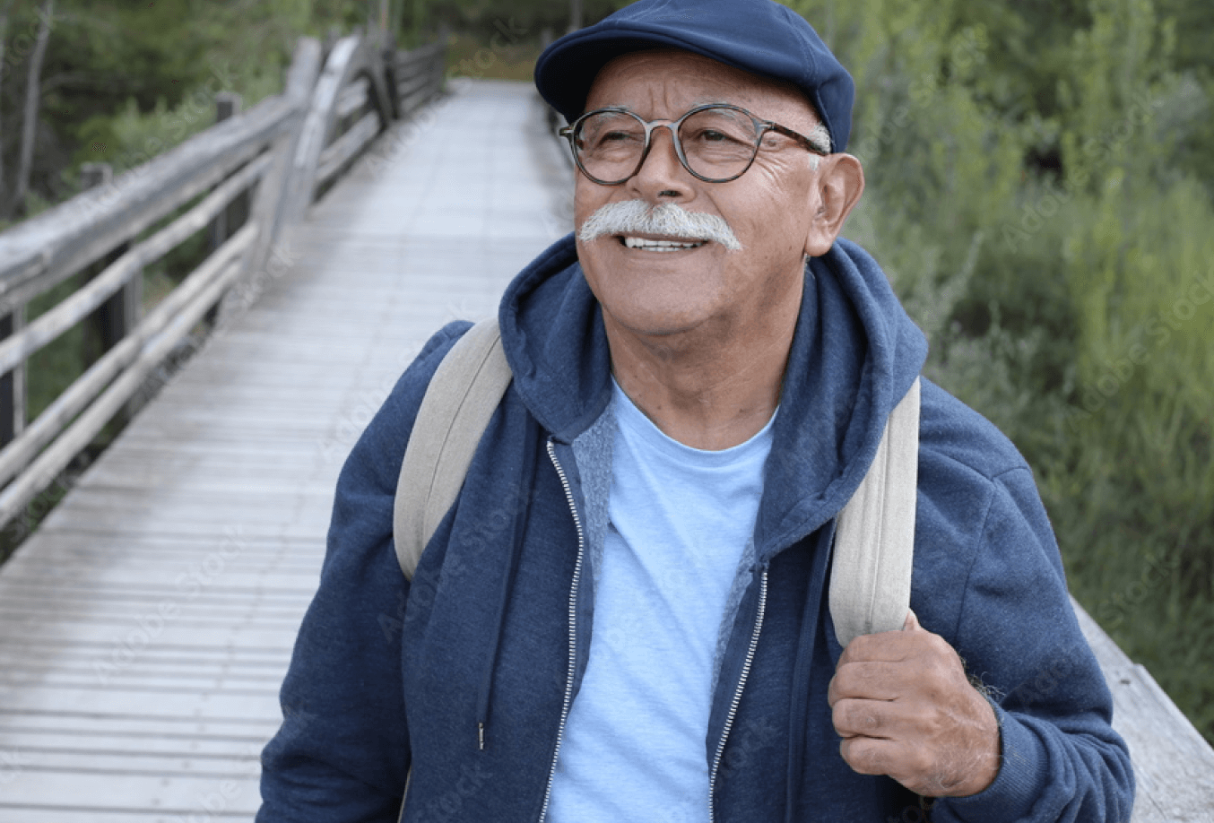 Elderly man walking on a wood bridge