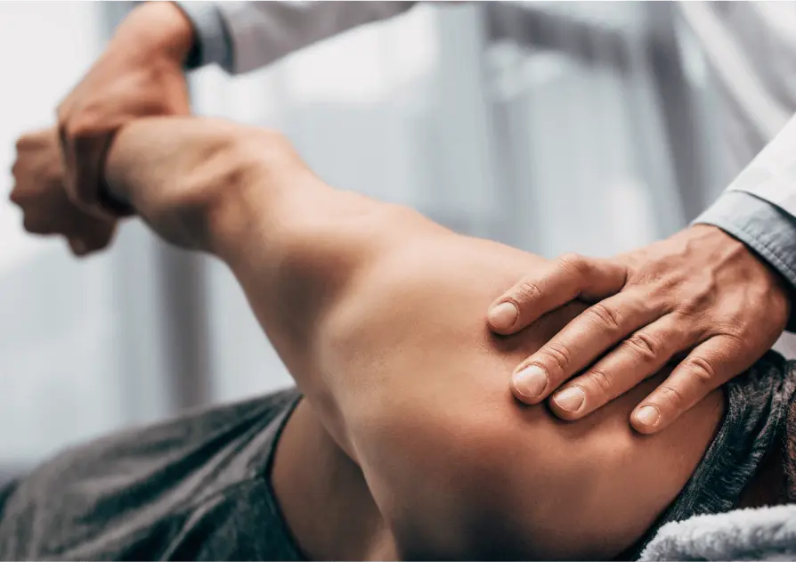 Doctor stretching patient's arm