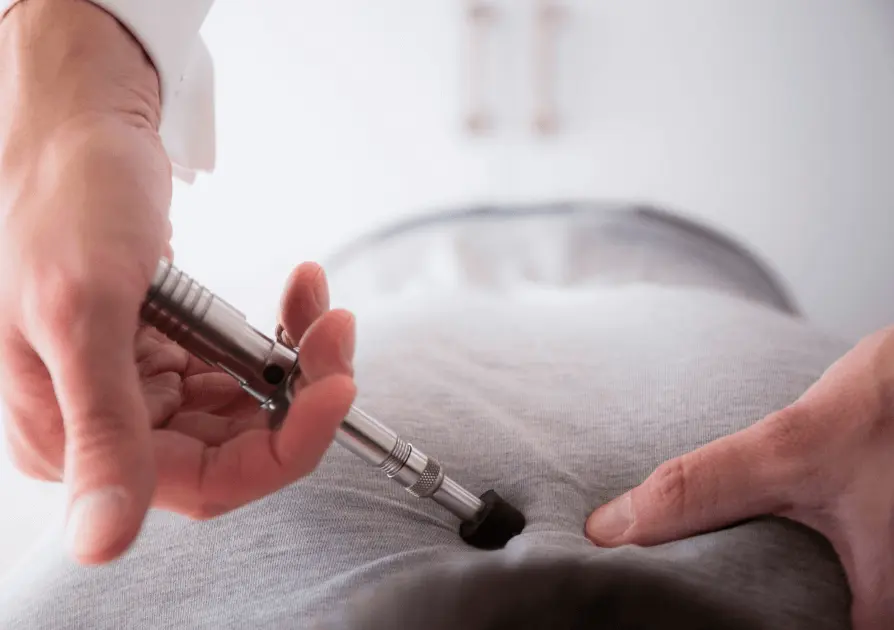 Patient's back being adjusted by doctor