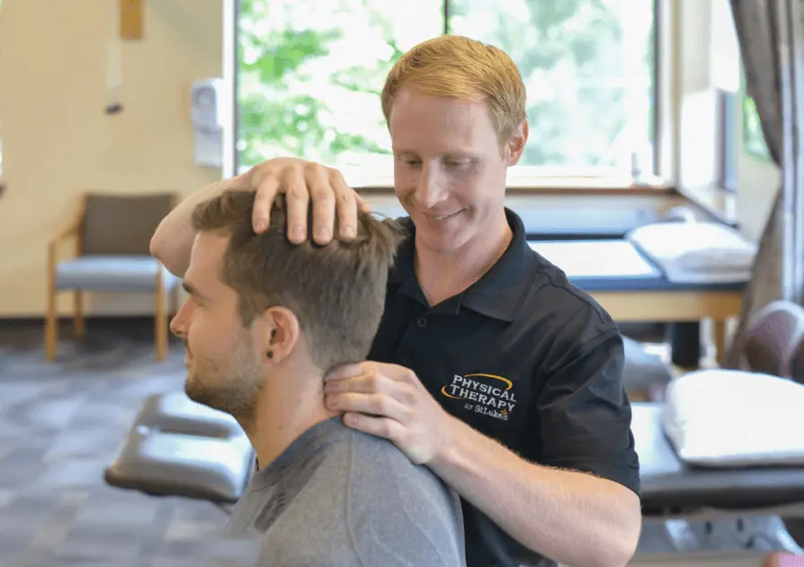 Physical Therapist stretching patient's neck