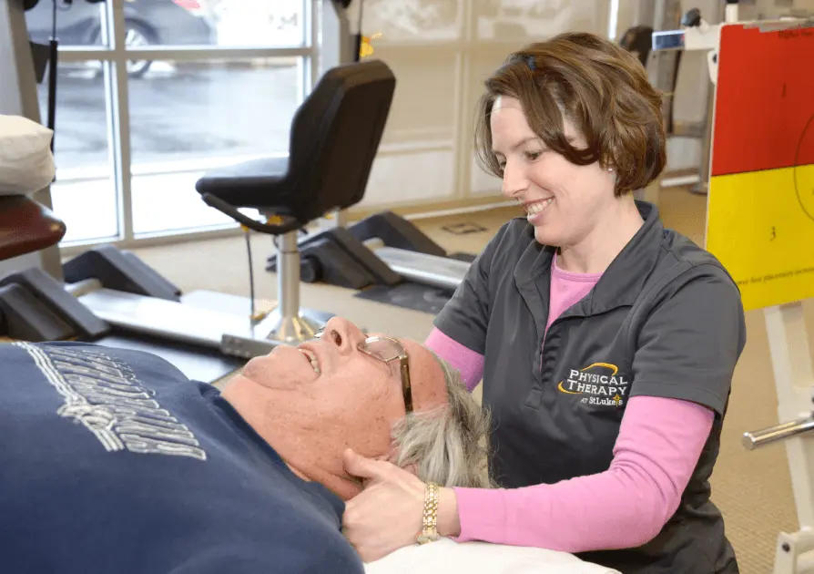 Physical Therapist stretching patient's neck