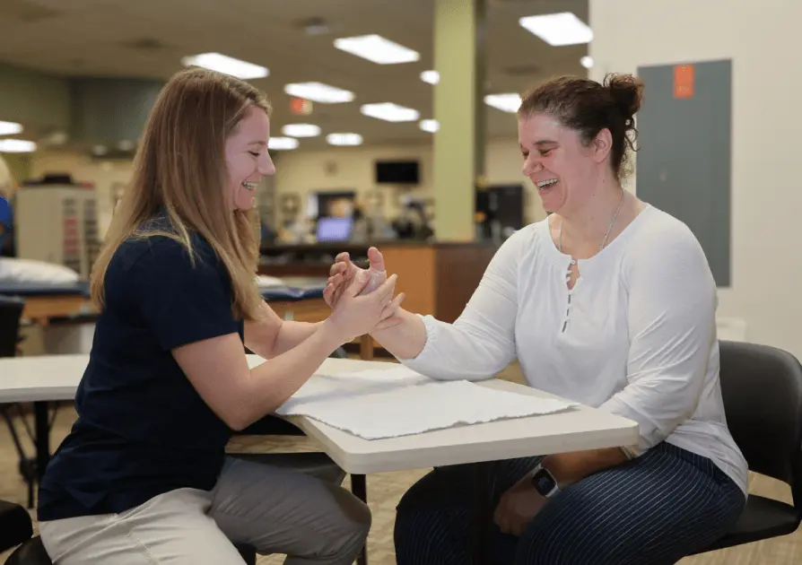 Physical Therapist sitting with patient