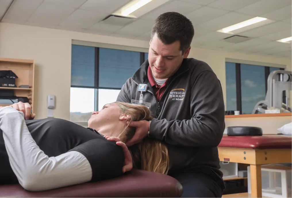 Patient's neck being stretched by a Physical Therapist