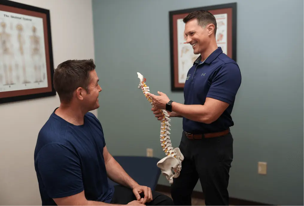 Physical Therapist teaching a patient about the spine