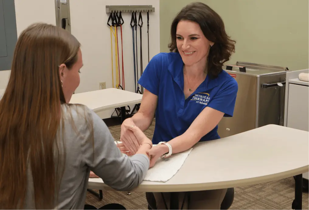 Physical Therapist stretching patient's wrist