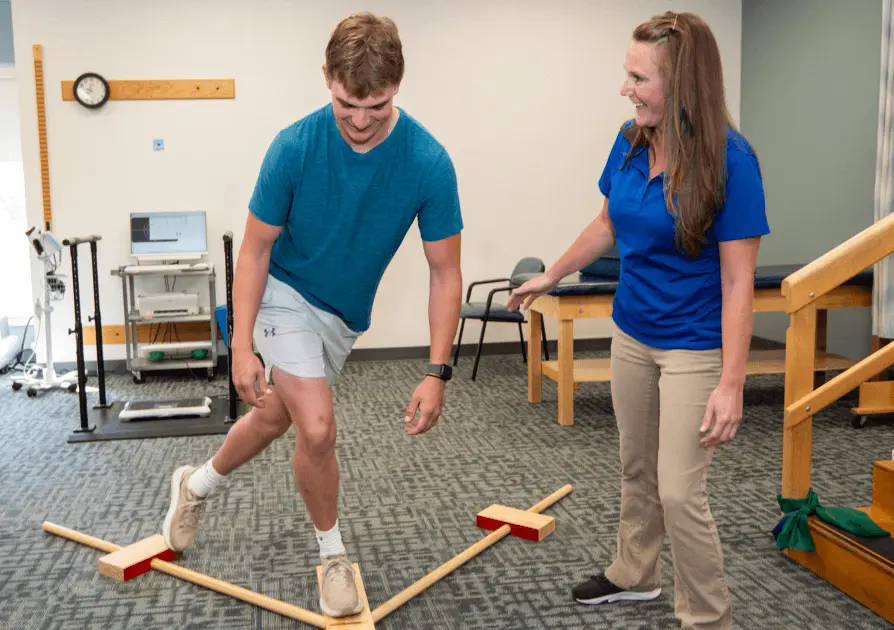 Physical Therapist helping patient with balance