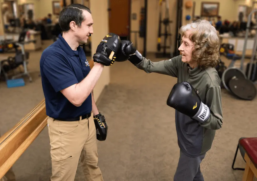 Physical Therapist boxing with patient