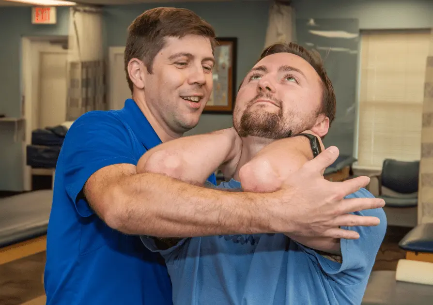 Physical Therapist stretching patient