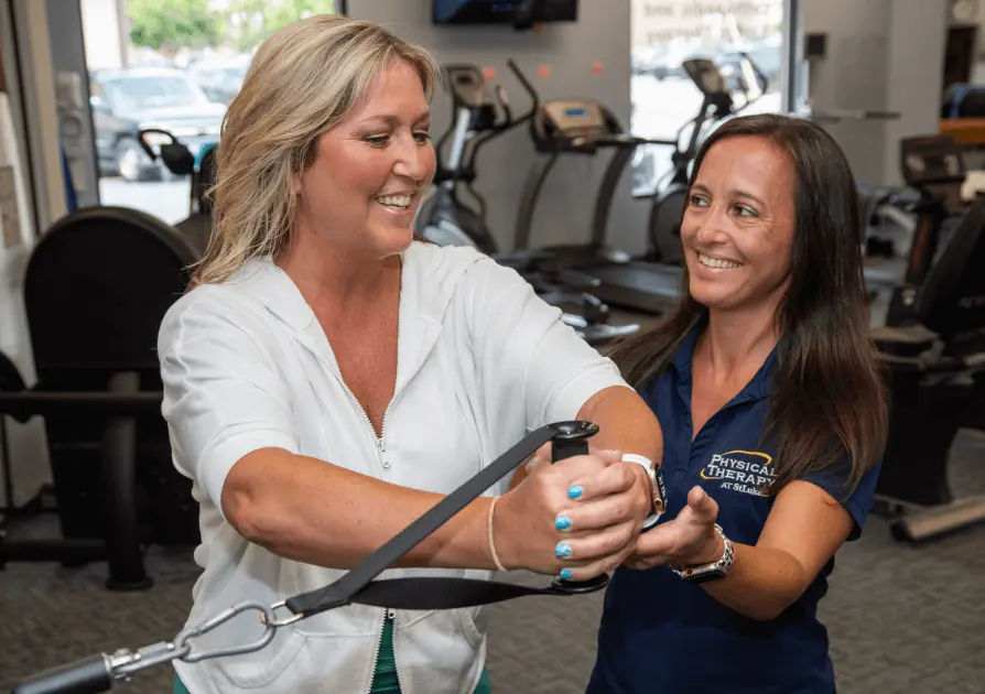 Physical Therapist helping a patient exercise