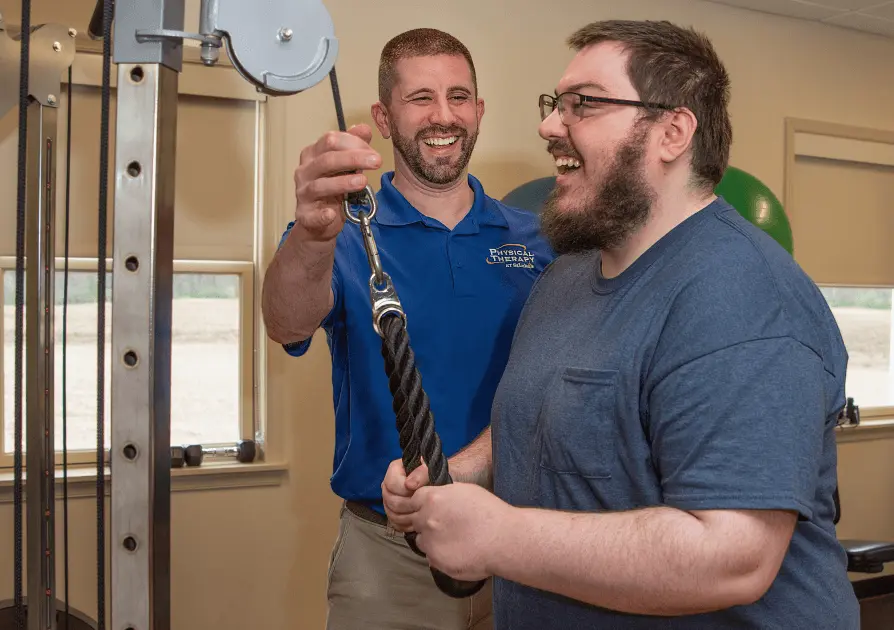 Physical Therapist helping a patient exercise