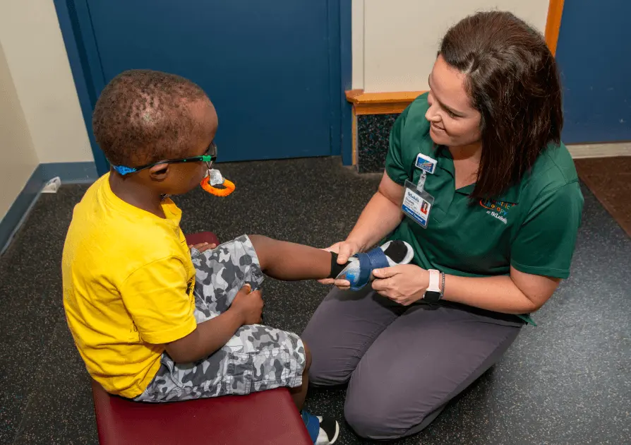 Physical Therapist helping young child