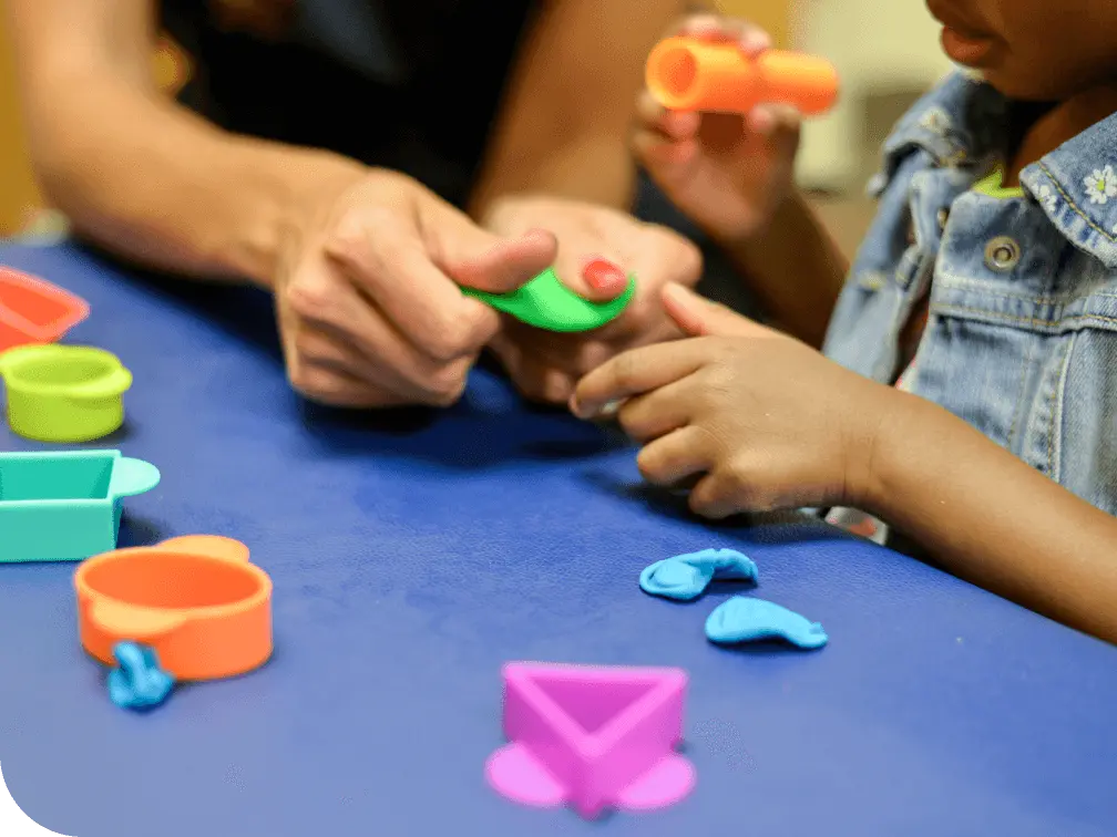 Physical Therapist playing with a young child