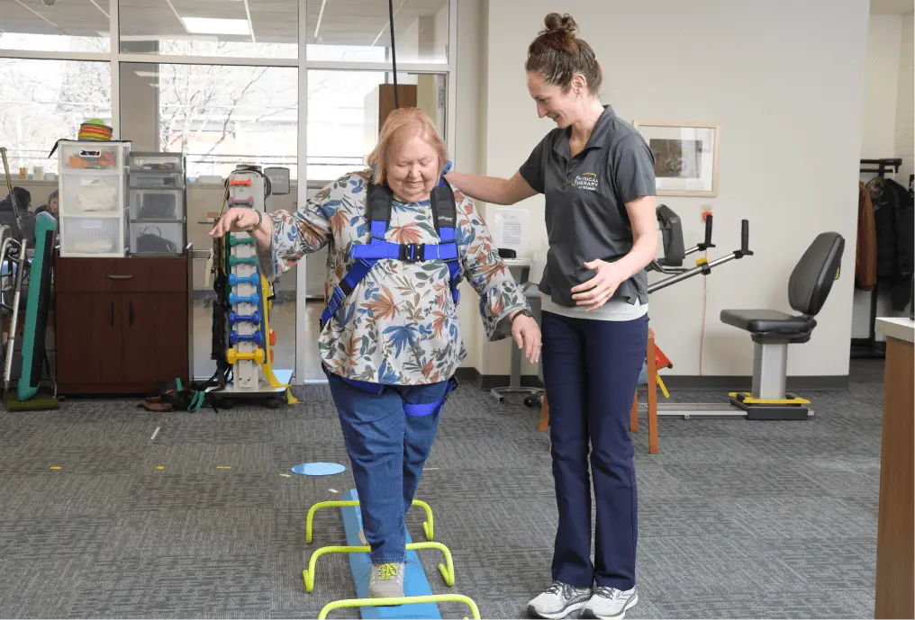 Physical Therapist helping patient walk