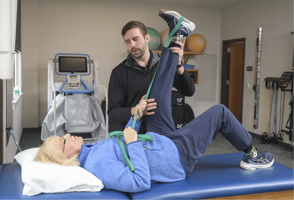 Physical Therapist stretching a patient