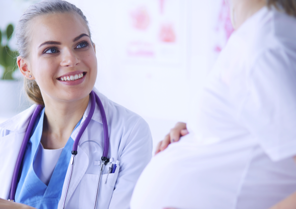 Doctor talking to pregnant patient