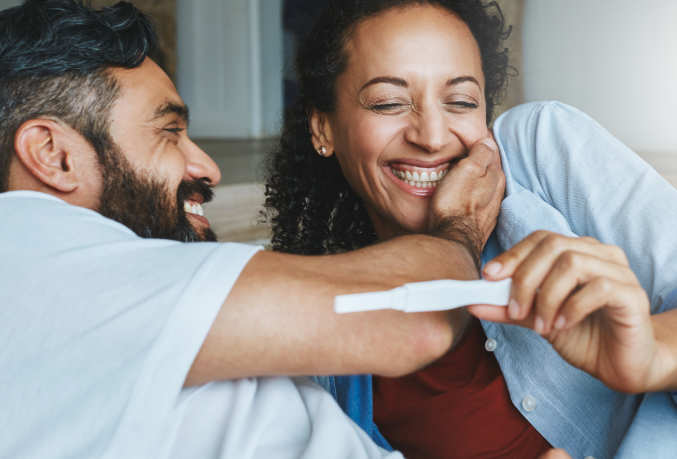 Couple celebrating a pregnancy test