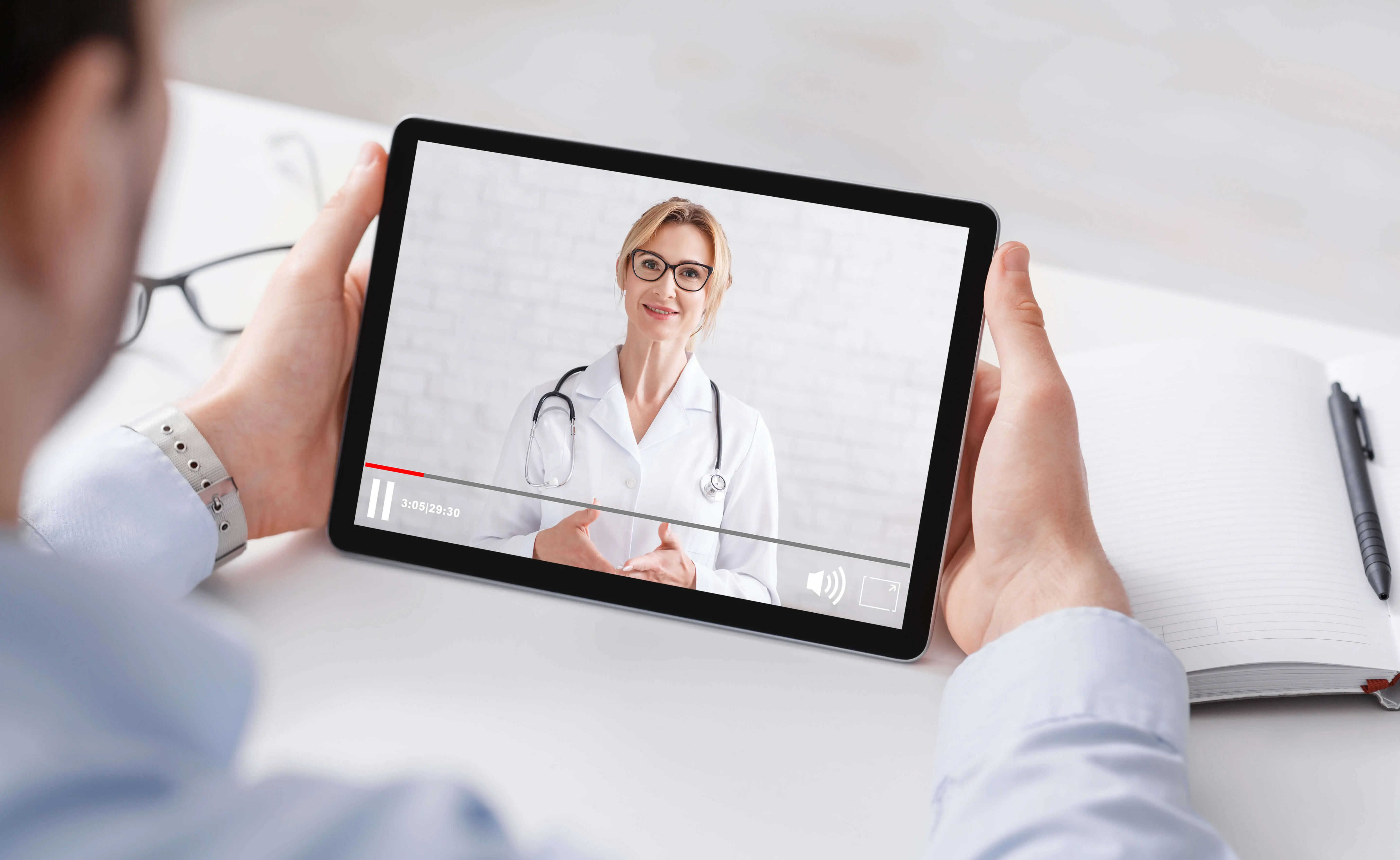 Doctor meeting with patient through mobile device